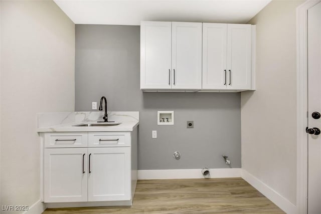 laundry area with gas dryer hookup, sink, hookup for a washing machine, electric dryer hookup, and cabinets