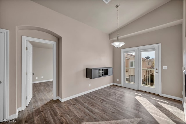 unfurnished living room featuring vaulted ceiling and wood-type flooring