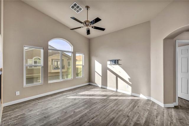 unfurnished living room featuring hardwood / wood-style floors, vaulted ceiling, and ceiling fan