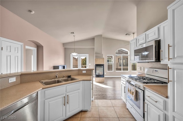 kitchen with pendant lighting, stainless steel appliances, sink, and white cabinets