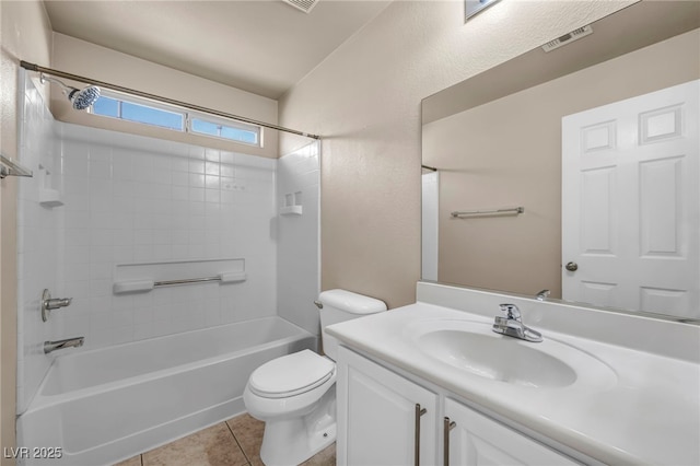 full bathroom with tile patterned flooring, vanity, tiled shower / bath combo, and toilet