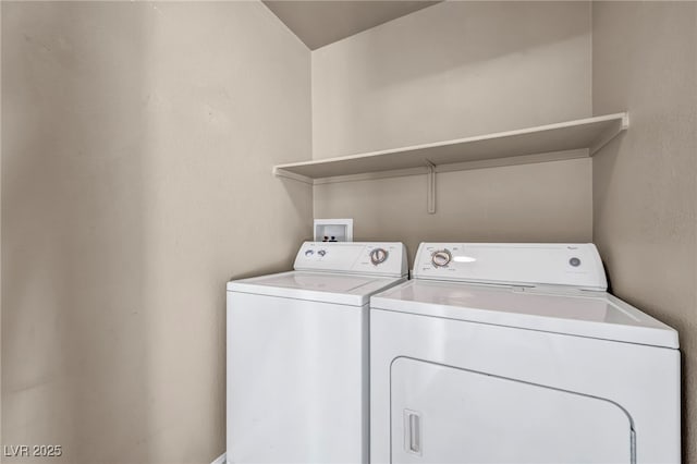 clothes washing area featuring washer and clothes dryer