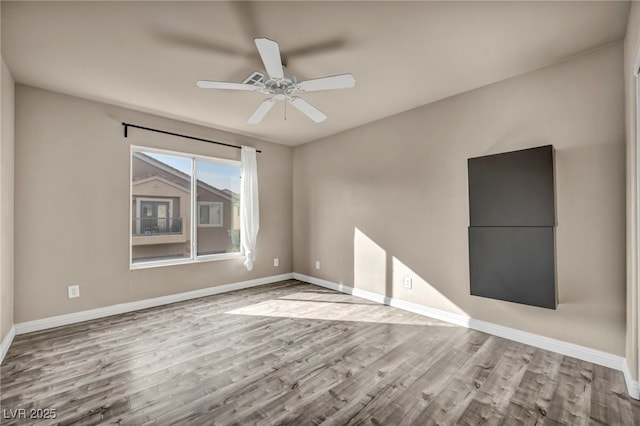 spare room featuring light hardwood / wood-style floors and ceiling fan