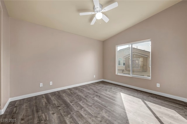 empty room with ceiling fan, wood-type flooring, and vaulted ceiling