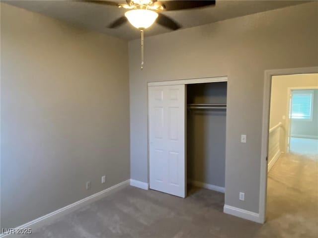 unfurnished bedroom with ceiling fan, a closet, and carpet floors