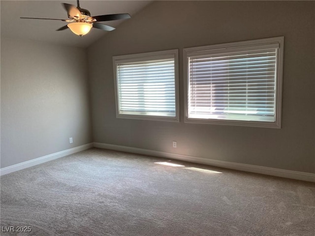 carpeted empty room with ceiling fan and lofted ceiling