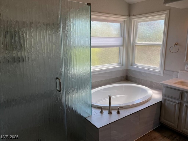 bathroom with vanity, a wealth of natural light, and shower with separate bathtub