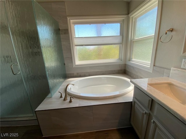 bathroom with independent shower and bath and vanity