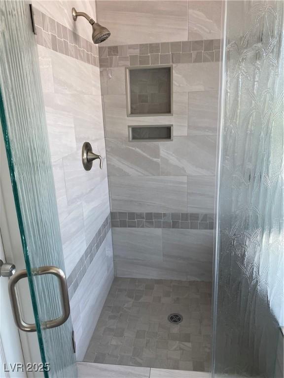 bathroom with a shower with shower door