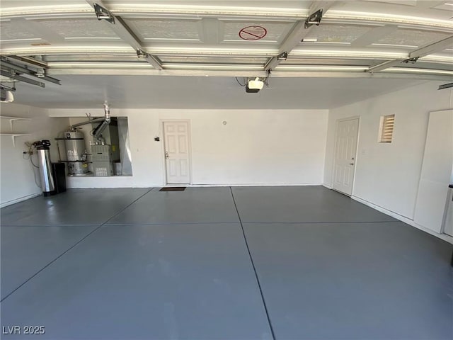 garage featuring heating unit, water heater, and a garage door opener