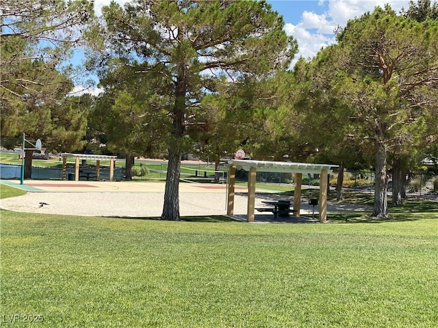 view of property's community with volleyball court and a yard