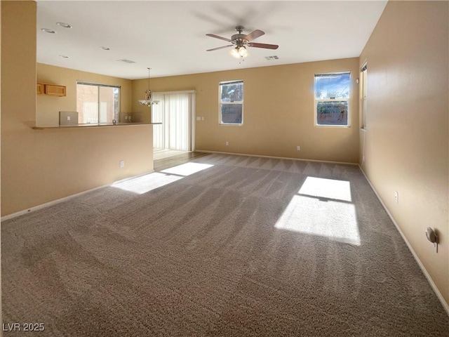 carpeted spare room with ceiling fan