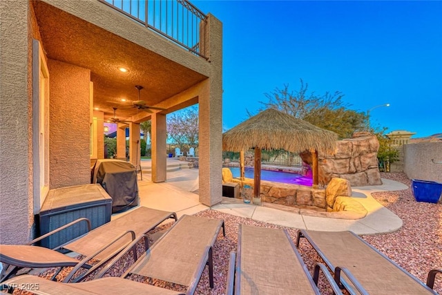 view of patio featuring a balcony, a gazebo, and ceiling fan