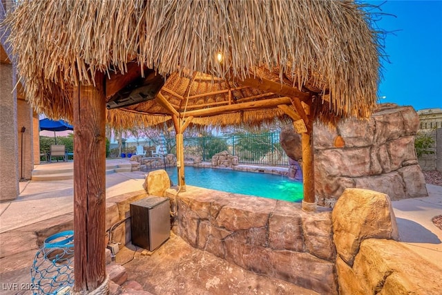 exterior space featuring a gazebo and pool water feature