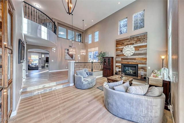 living room with a towering ceiling and hardwood / wood-style floors