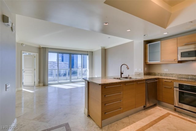 kitchen with sink, crown molding, kitchen peninsula, and appliances with stainless steel finishes