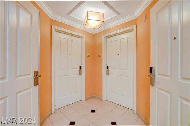 foyer with ornamental molding and light tile patterned floors