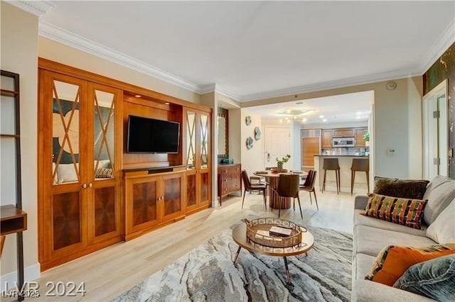 living room with ornamental molding and light wood-type flooring