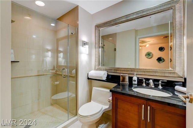 bathroom with toilet, an enclosed shower, and vanity