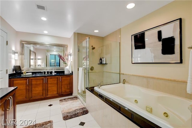 bathroom featuring independent shower and bath, tile patterned floors, and vanity