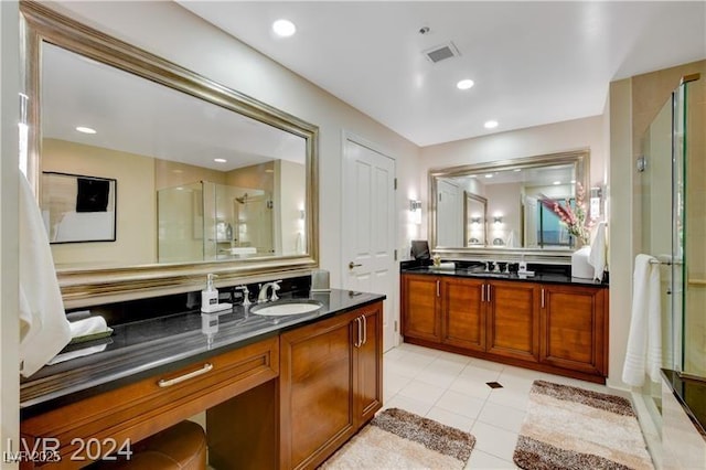 bathroom with vanity, an enclosed shower, and tile patterned flooring