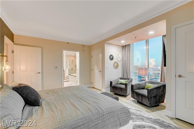 bedroom with connected bathroom and ornamental molding