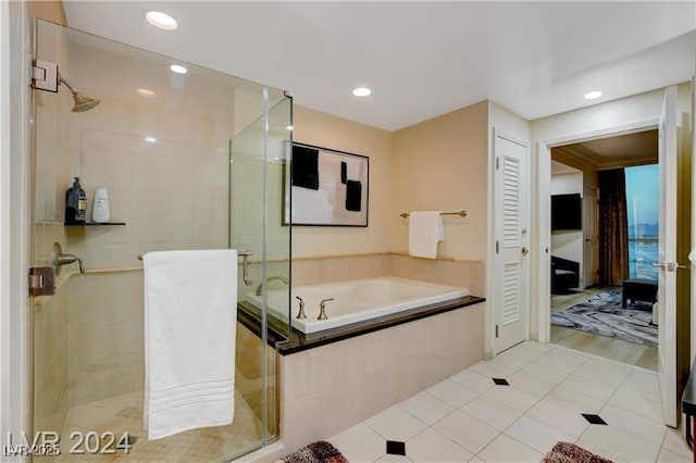 bathroom with independent shower and bath and tile patterned flooring