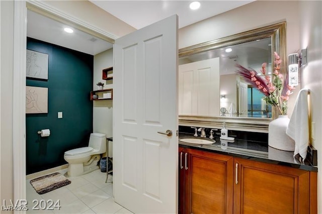 bathroom with toilet, tile patterned flooring, and vanity