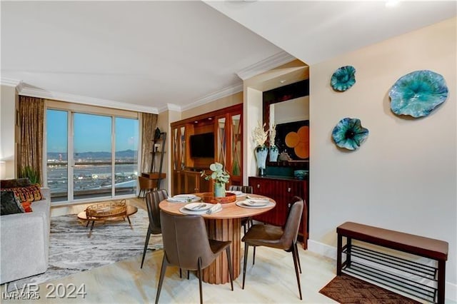 dining space with crown molding