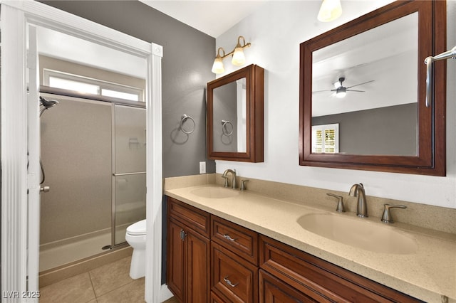 bathroom featuring a wealth of natural light, a shower with door, vanity, and tile patterned flooring