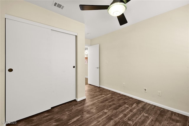 unfurnished bedroom with a closet, ceiling fan, and dark hardwood / wood-style floors