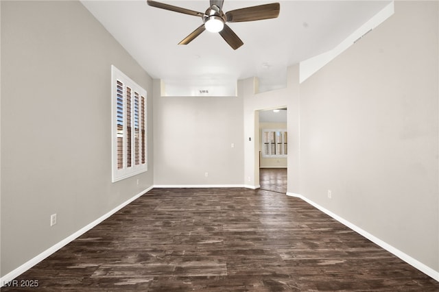 spare room featuring dark wood-type flooring and ceiling fan