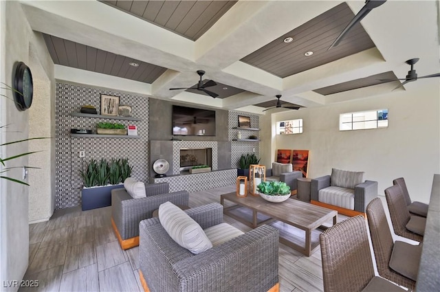 living room featuring a tiled fireplace and ceiling fan