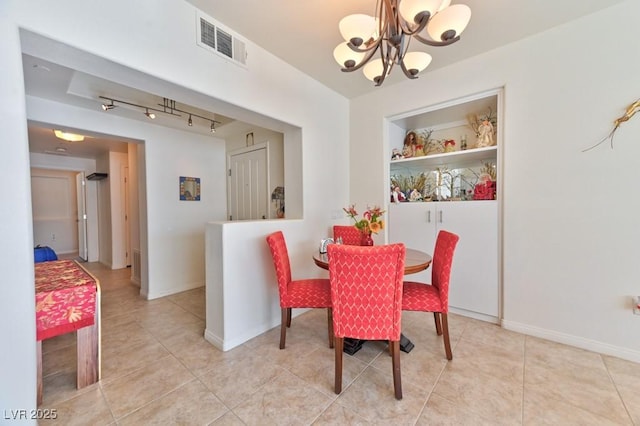 dining room with an inviting chandelier and light tile patterned floors