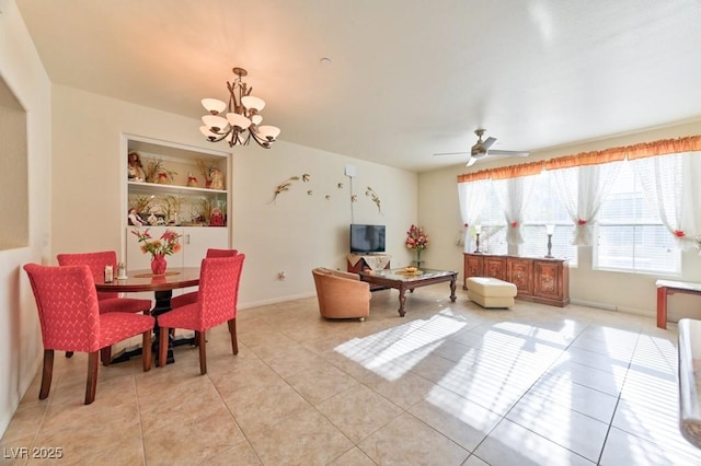 dining space featuring ceiling fan with notable chandelier and light tile patterned floors