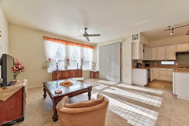 tiled living room with ceiling fan