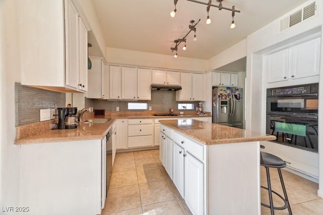 kitchen featuring white cabinetry, black appliances, and a center island