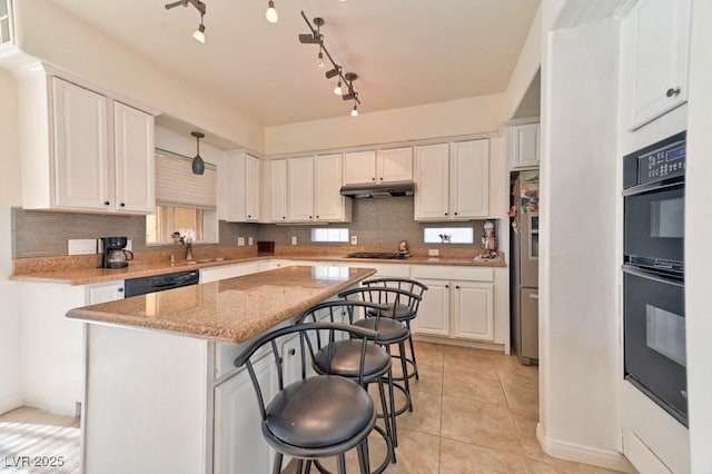 kitchen featuring a kitchen bar, a center island, white cabinets, light stone countertops, and black appliances