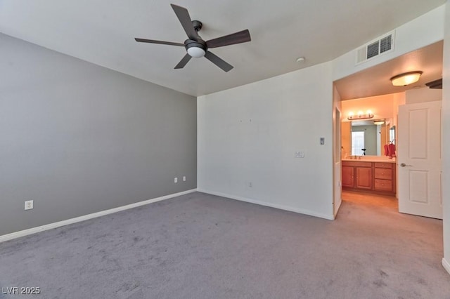 unfurnished room with ceiling fan and carpet