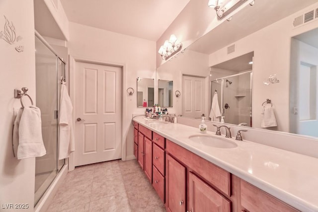 bathroom with vanity, an enclosed shower, and tile patterned flooring