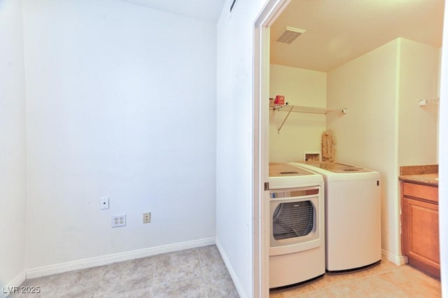 laundry room featuring washer and dryer and light tile patterned floors