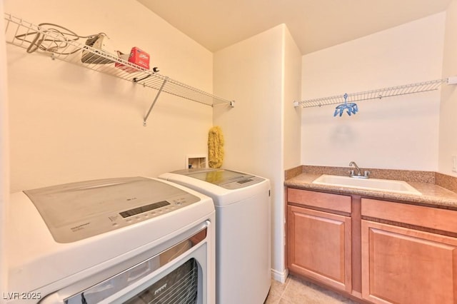 washroom with washer and dryer, sink, and light tile patterned floors