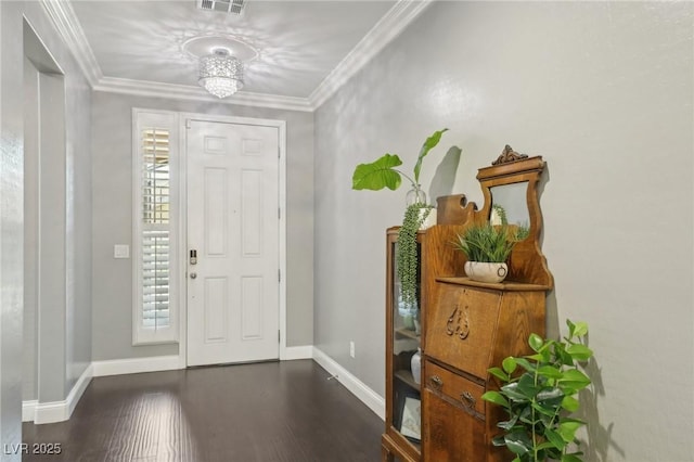 foyer with ornamental molding and dark hardwood / wood-style flooring