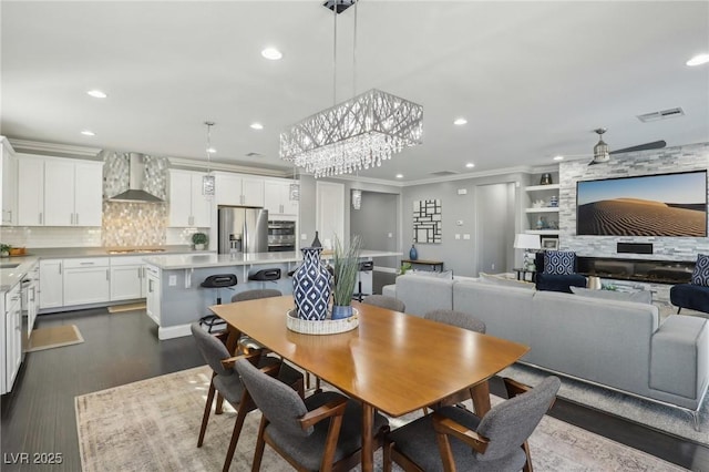 dining area with dark wood-type flooring, sink, and ornamental molding