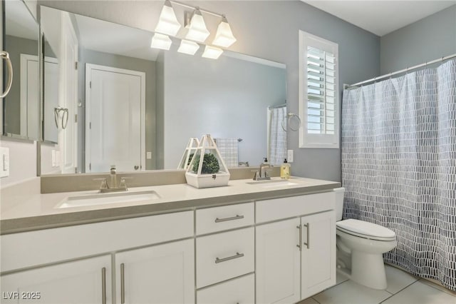 bathroom featuring toilet, tile patterned floors, and vanity