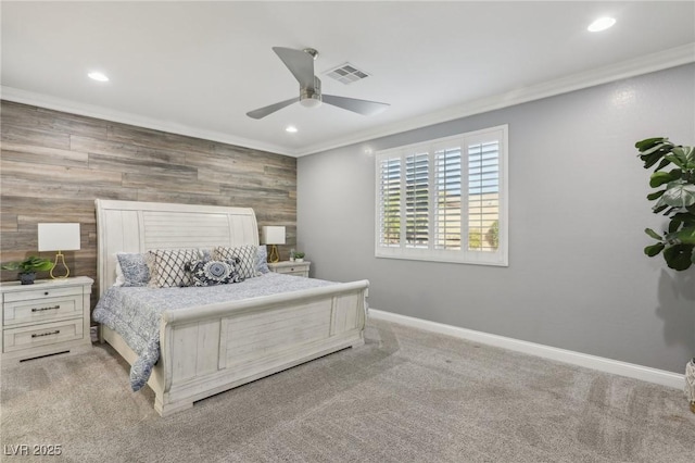 bedroom featuring ceiling fan, light carpet, ornamental molding, and wood walls