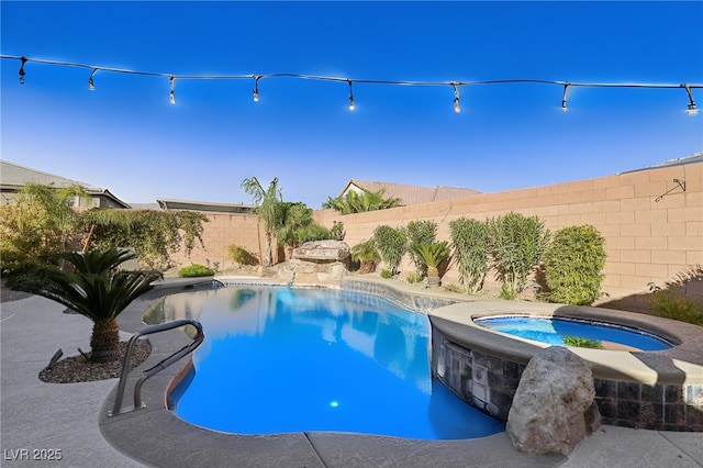 view of pool with an in ground hot tub