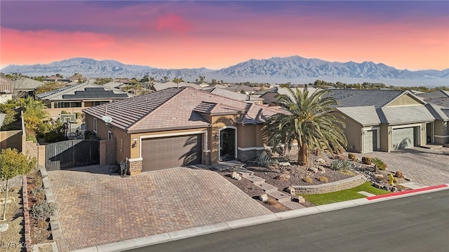 ranch-style home with a mountain view and a garage