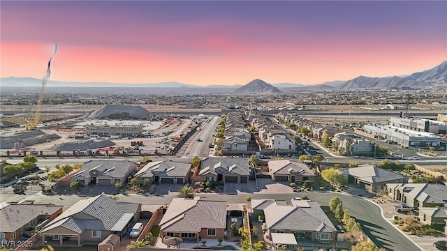 aerial view at dusk featuring a mountain view