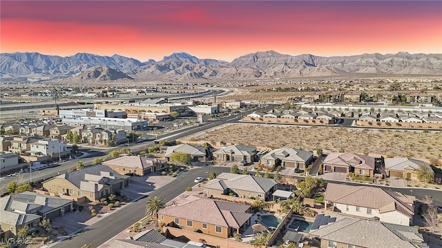 aerial view at dusk featuring a mountain view